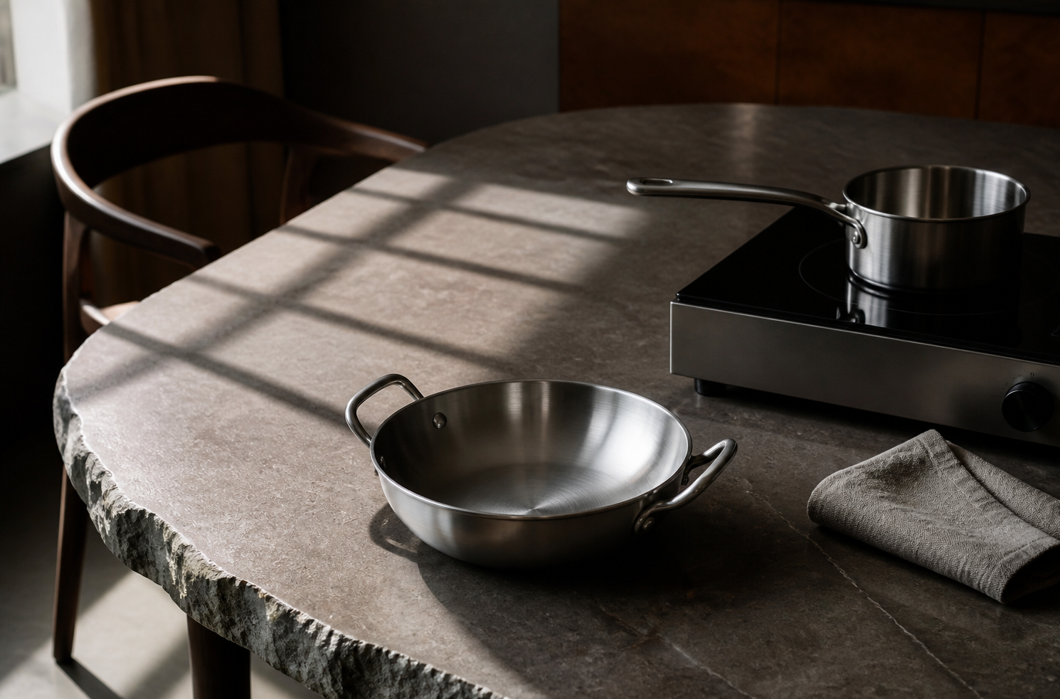 Cookware and a kitchen appliance on a stone table